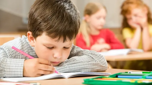 child-holding-pencil1-1024x683-1.webp
