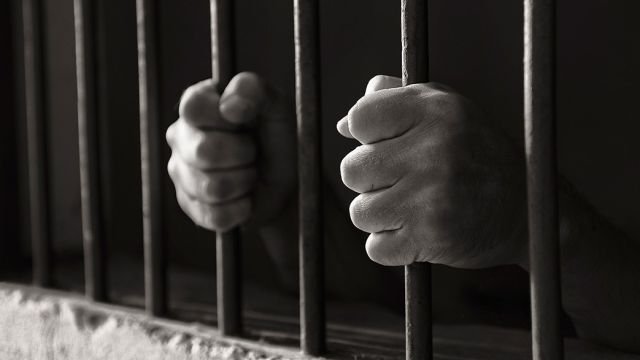 prison_bars_hands.jpg